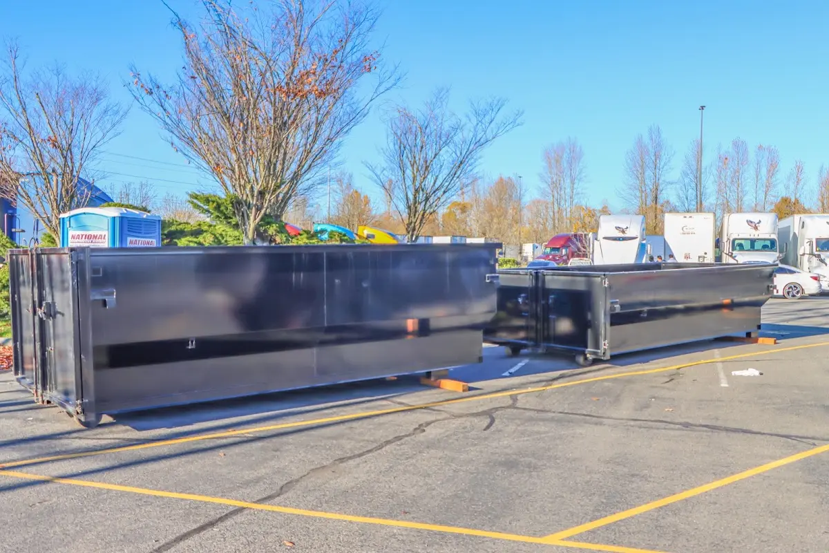 Professional dumpster rental service with roll-off container on residential driveway in Hollymead